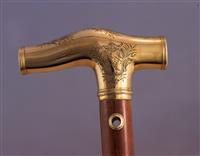 X1042 - gold headed cane, handle detail with arms, right hand side.jpg; X1042; The gold headed cane; Cane